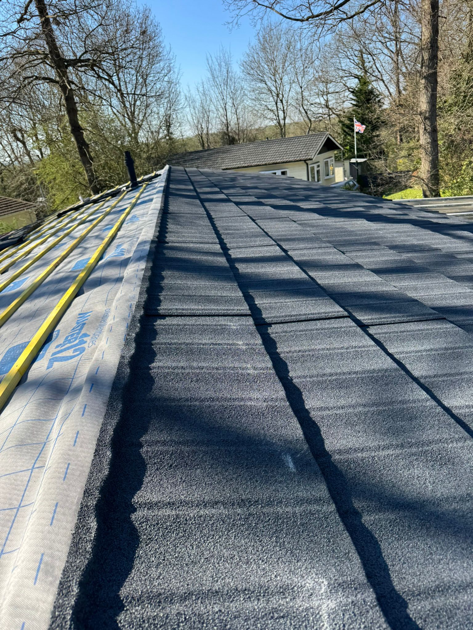 New roof tiles being laid with breathable membrane on a park home