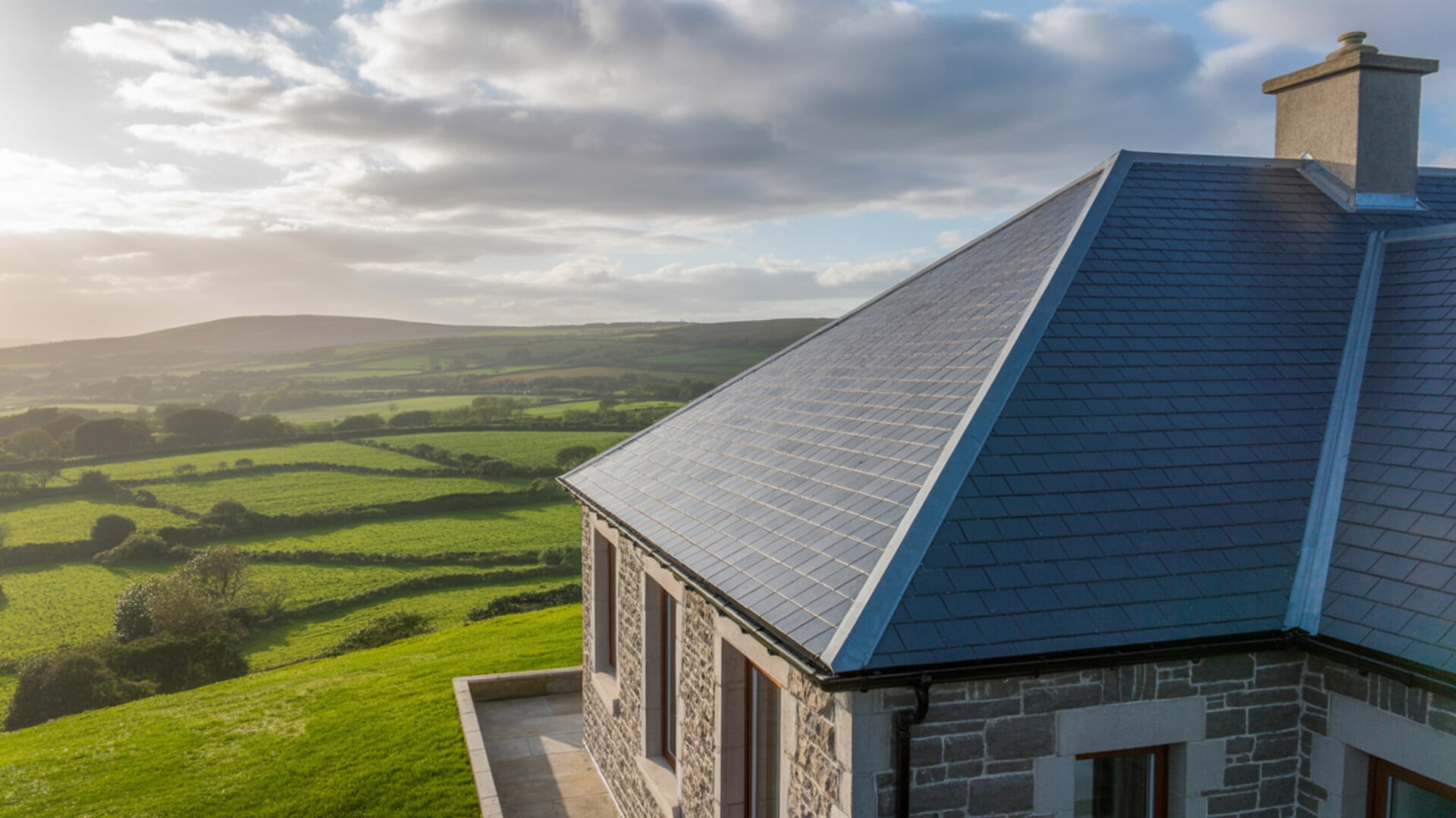 Traditional Irish house with pristine slate roof in green Galway countryside