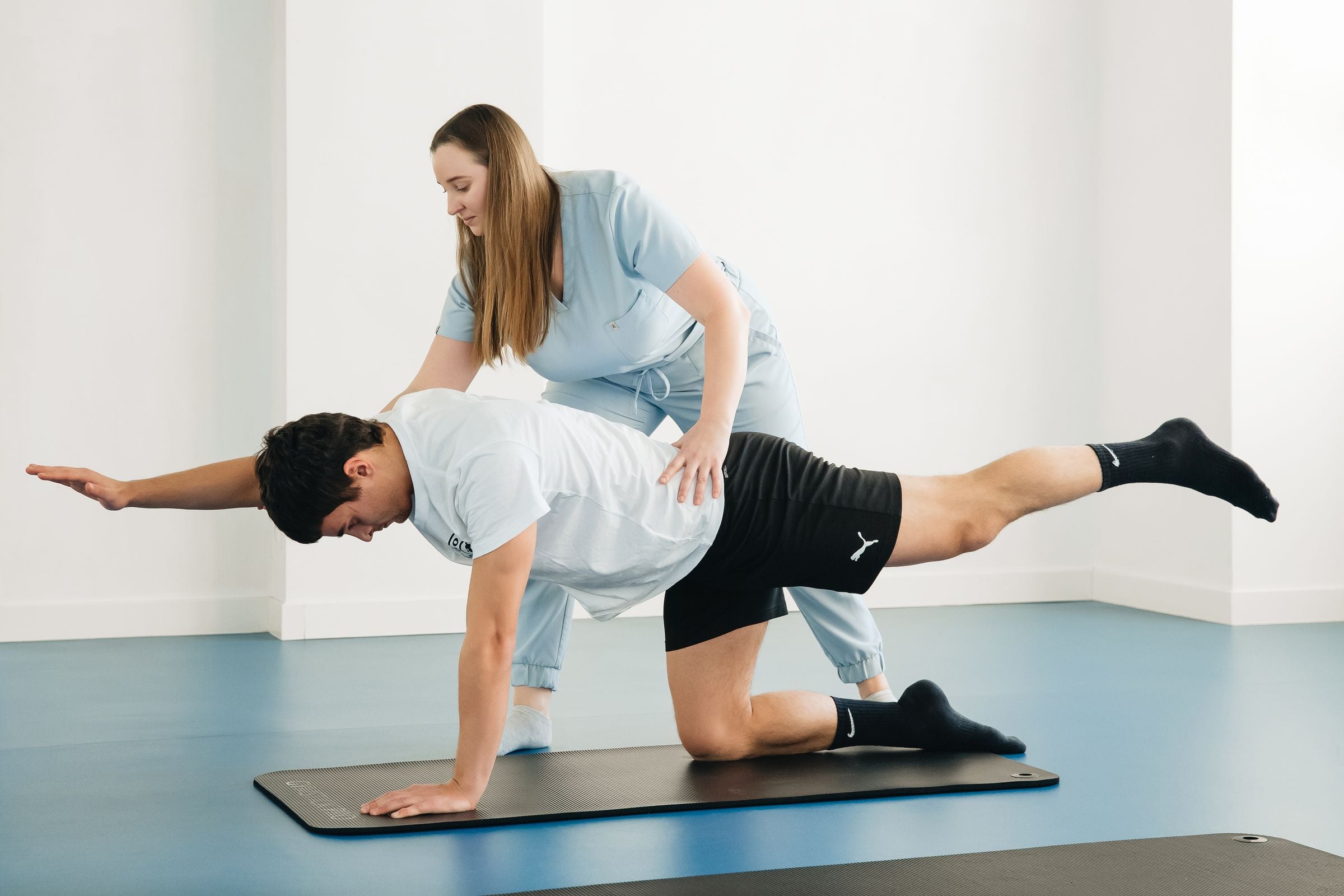 Physiotherapist guiding a patient through a rehabilitation exercise