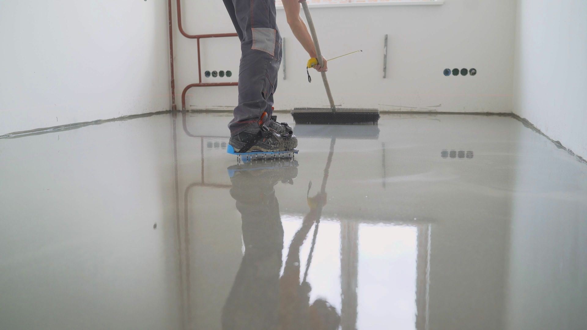 Liquid screed being poured for a smooth floor finish