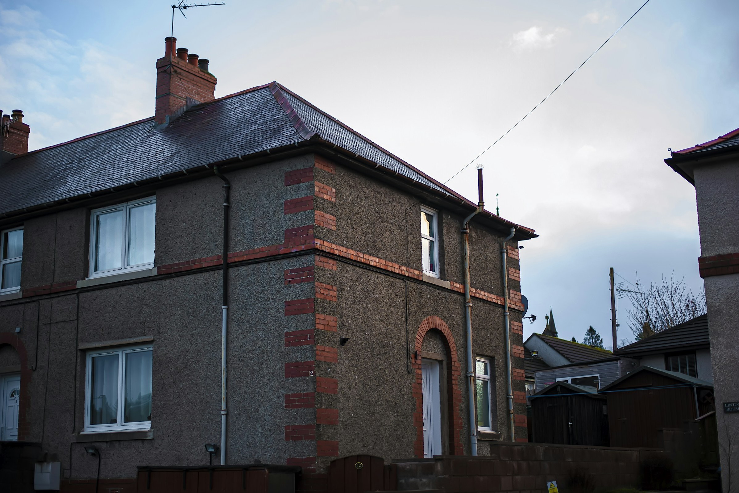 Semi-detached house with new black guttering