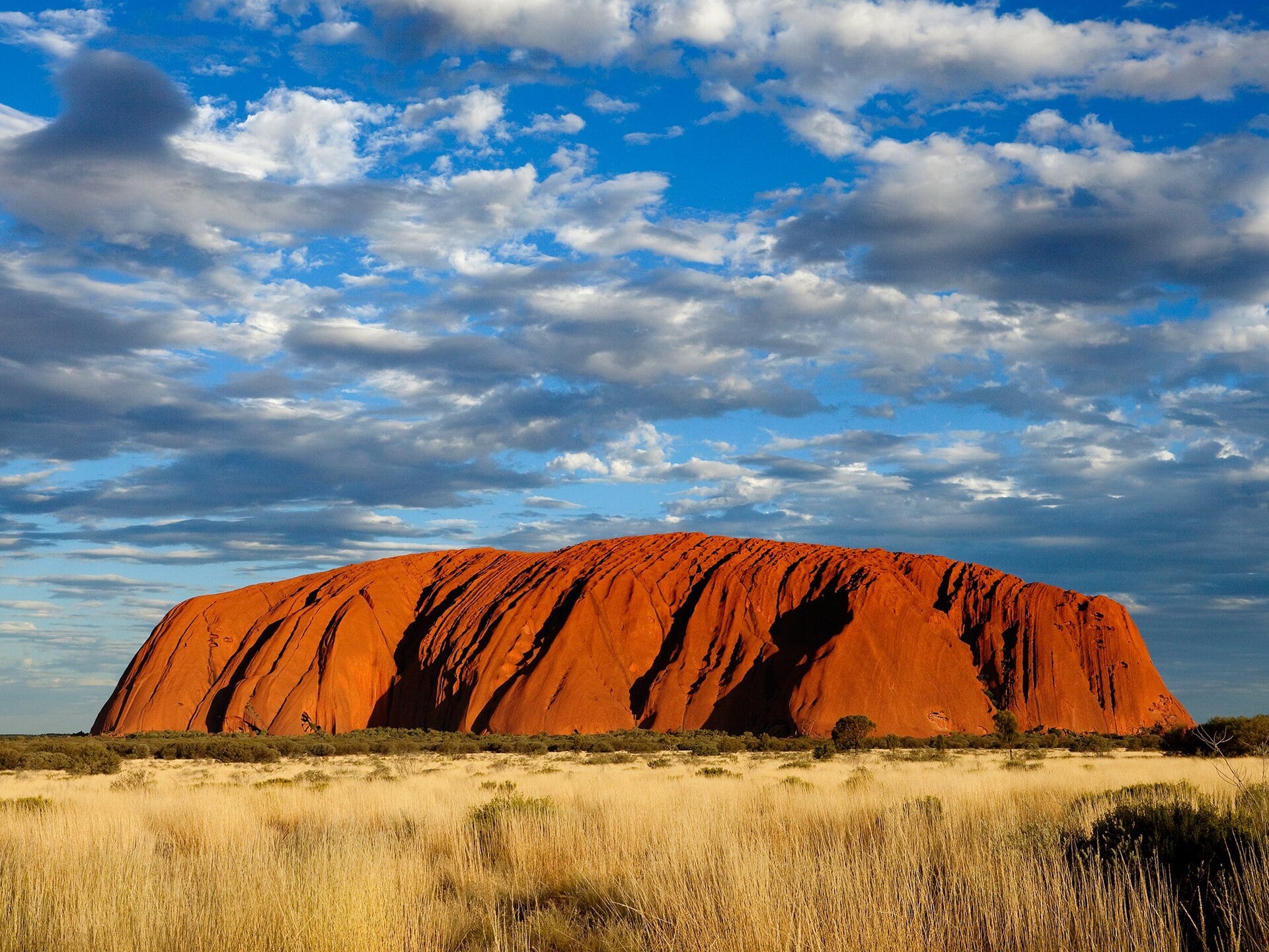 Red monolith of Uluru at sunset