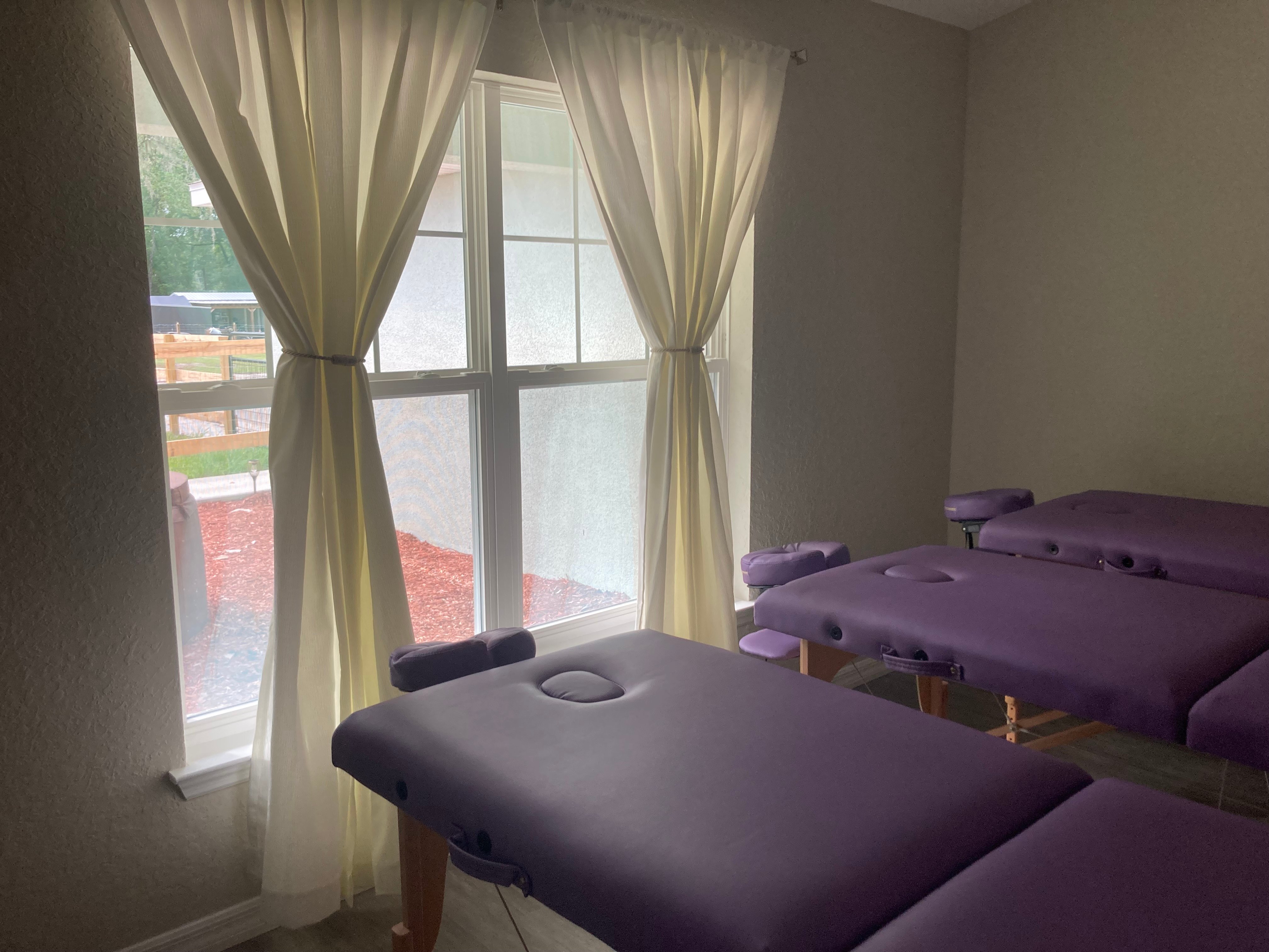Three lavender Spinal Flow tables set up by the window in our Marion County studio