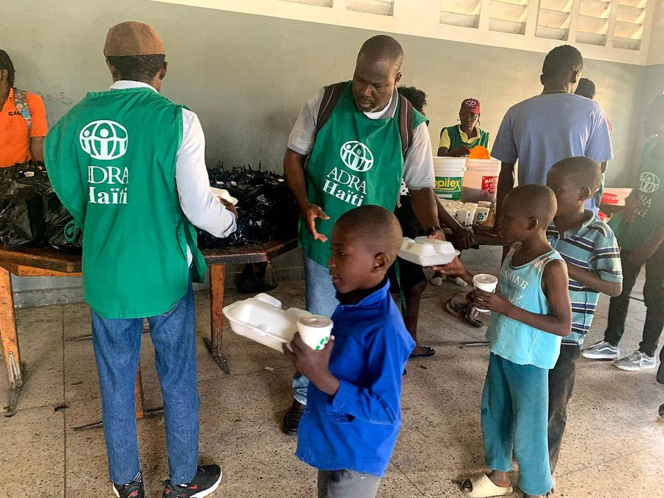 Volunteers distributing supplies to families in Haiti