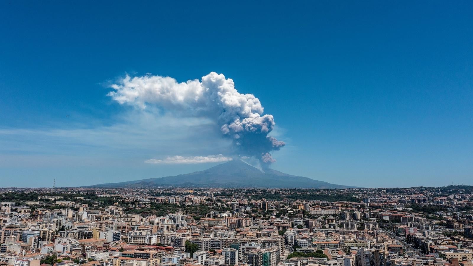 Mount Etna erupting with lava and smoke