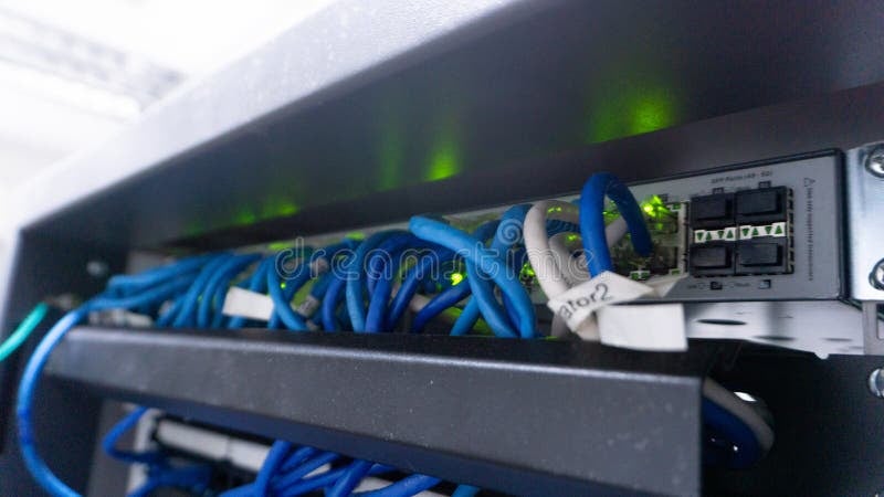 Network switches and fiber optic cables with blue LEDs