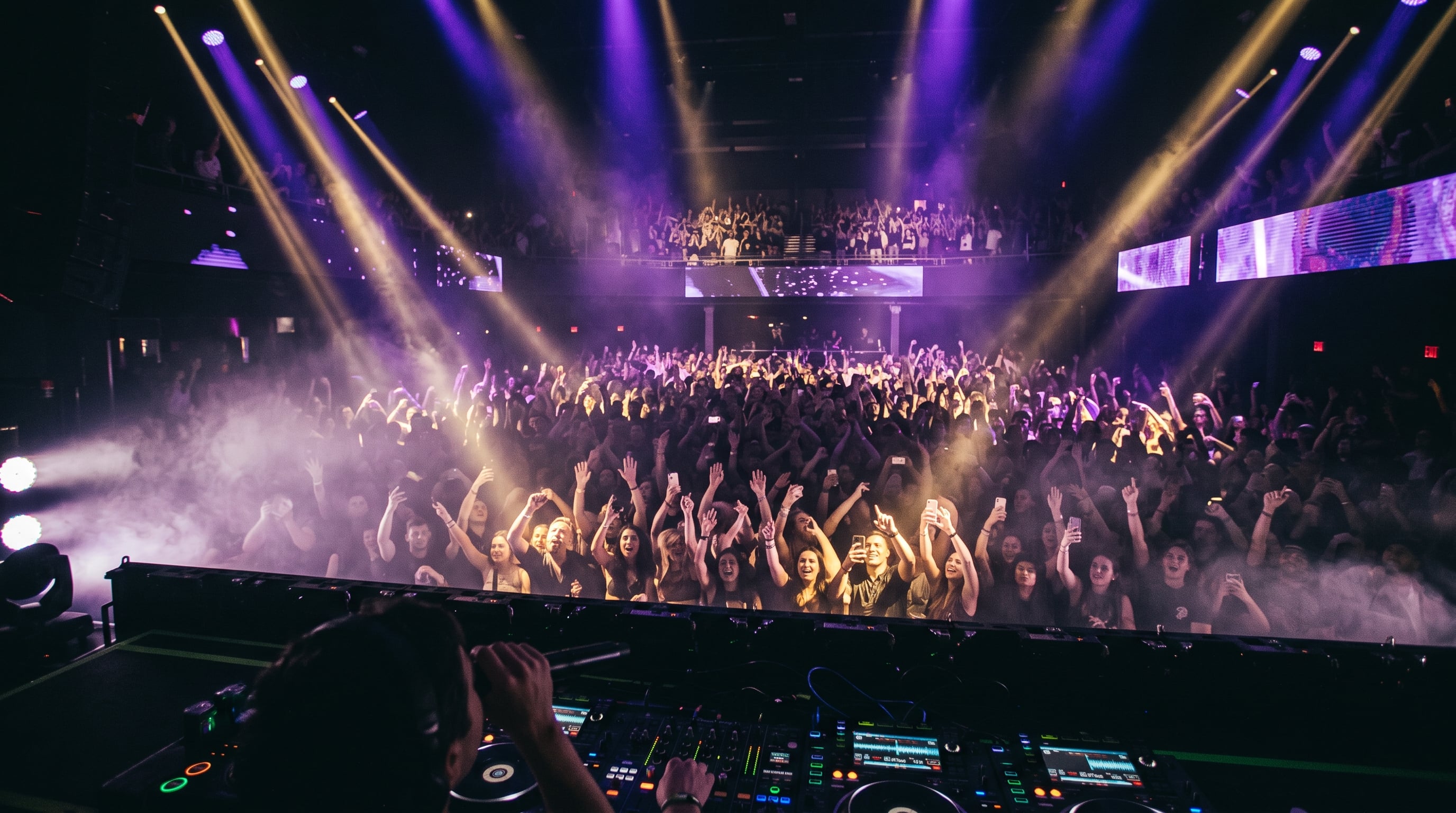 Live event stage with an engaged audience bathed in purple and gold light