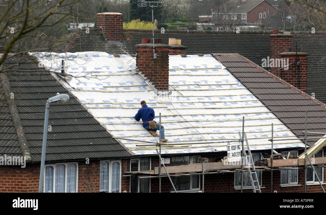 Professional roofer at work on residential property