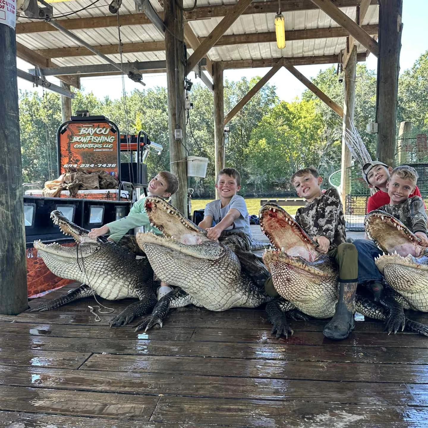 Two hunters with a large alligator in the Louisiana marsh