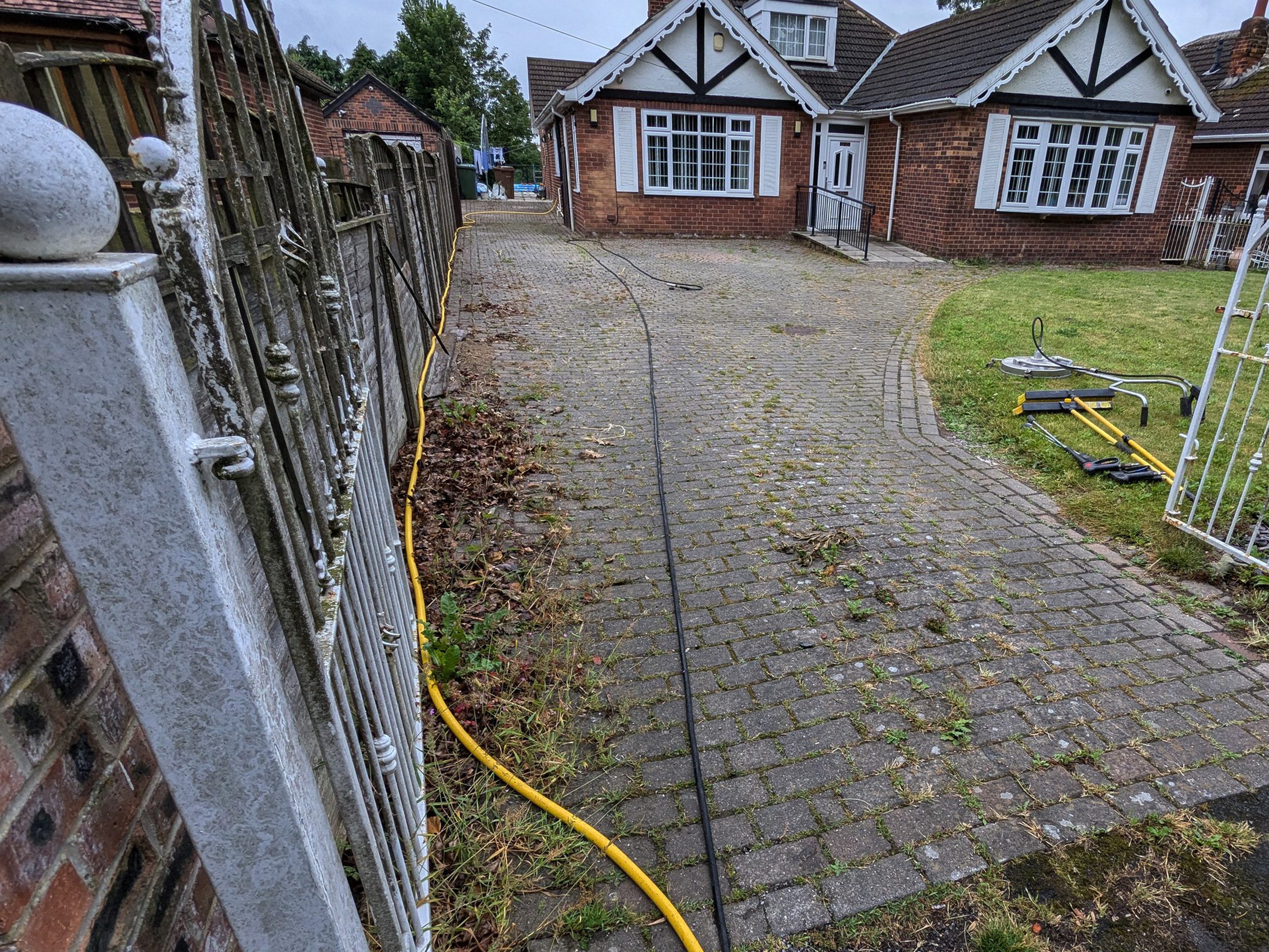 Dirty driveway with stains and moss before professional pressure washing service in York