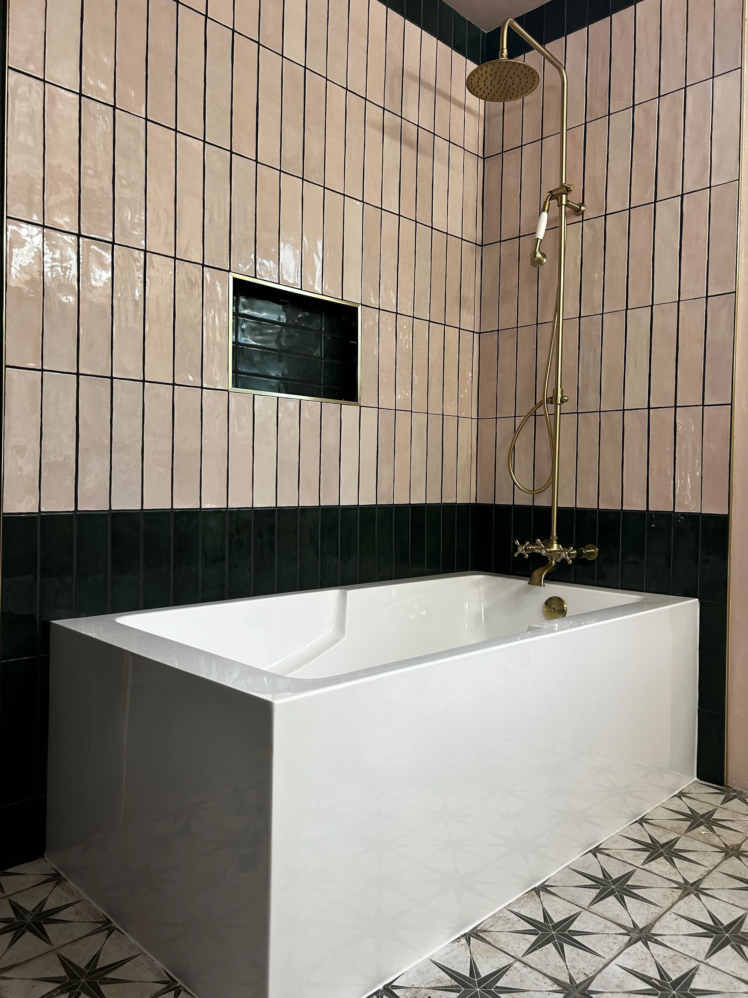 Elegant bathroom with pink tiles and brass fixtures