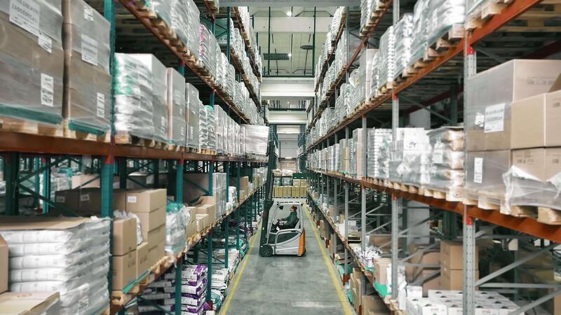 Aerial view of an organised warehouse with shelving and staged parcels