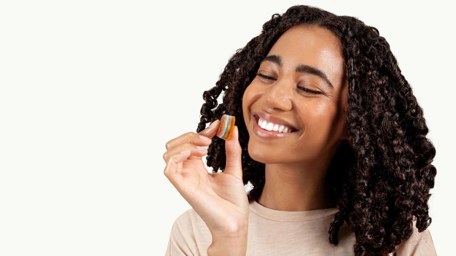 Person happily taking a Pure Himalayan Shilajit gummy supplement