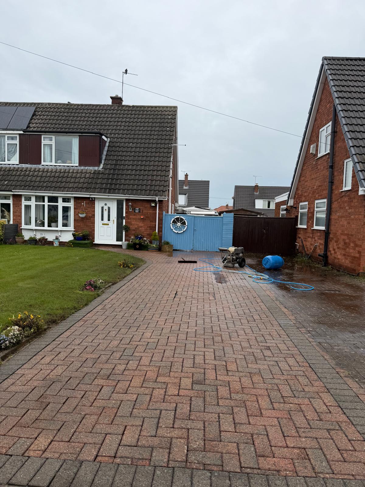 Brick-paved UK driveway before cleaning, generator set up