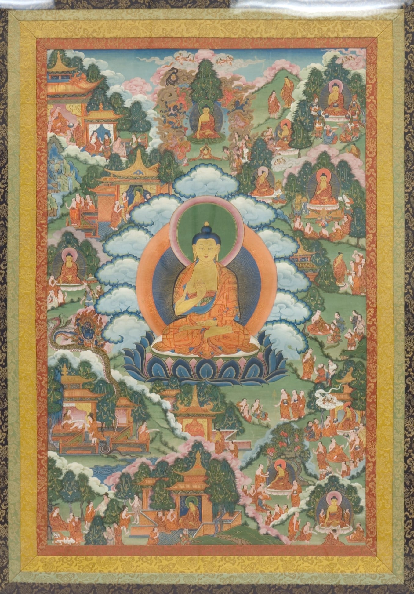 An eighteenth-century Tibetan thangka painting of a seated figure with mineral pigments and gold
