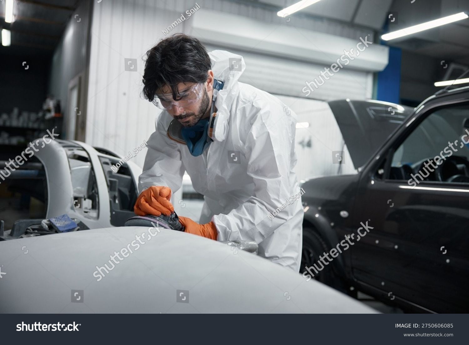 Professional auto body technician working on a vehicle