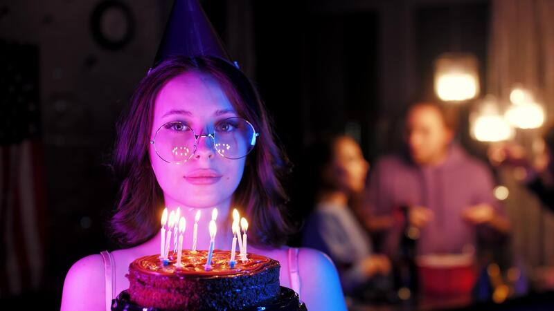 Woman holding birthday cake with sparklers