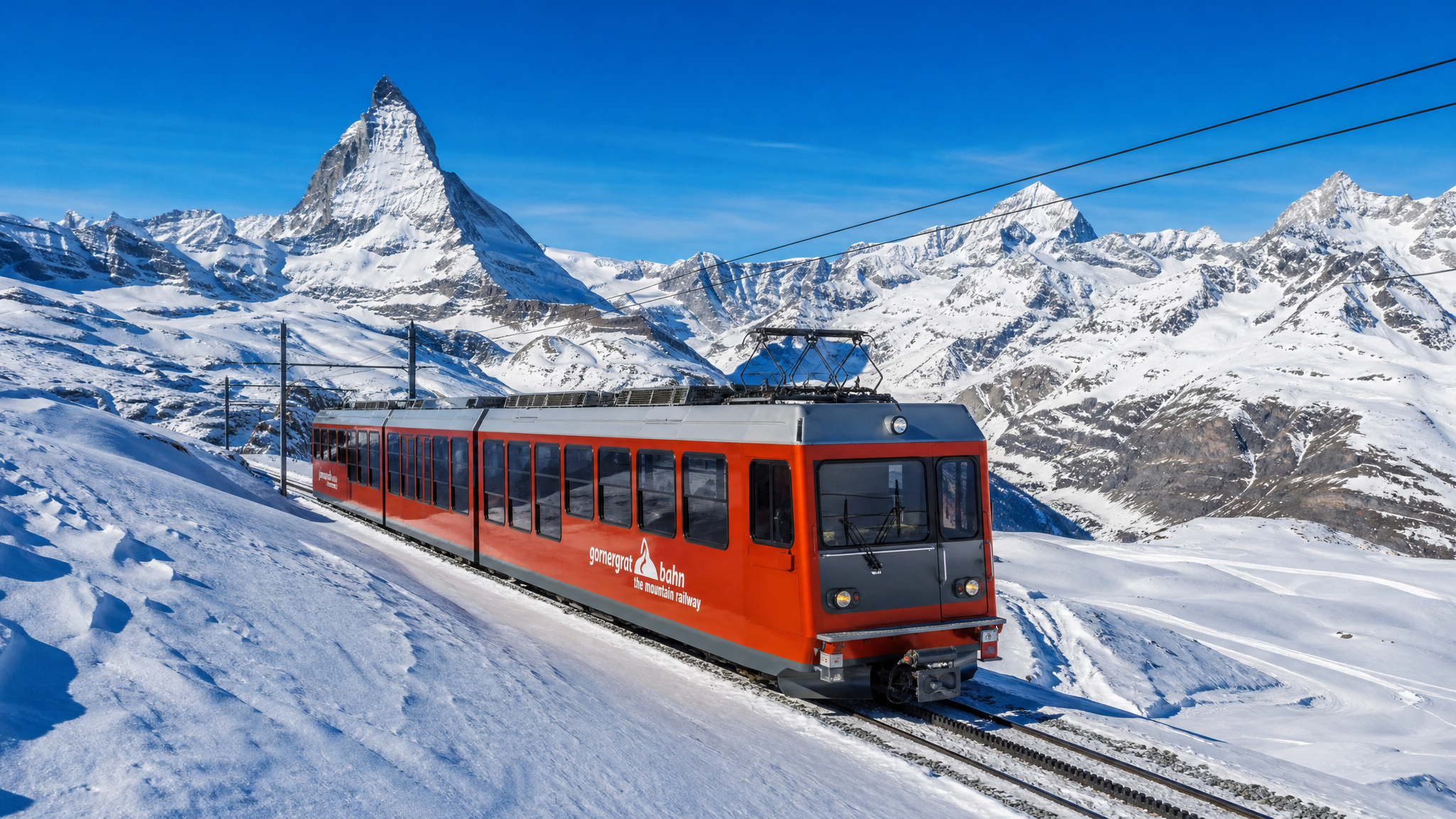 Red Swiss Alpine train travelling through the snowy mountains near Zermatt