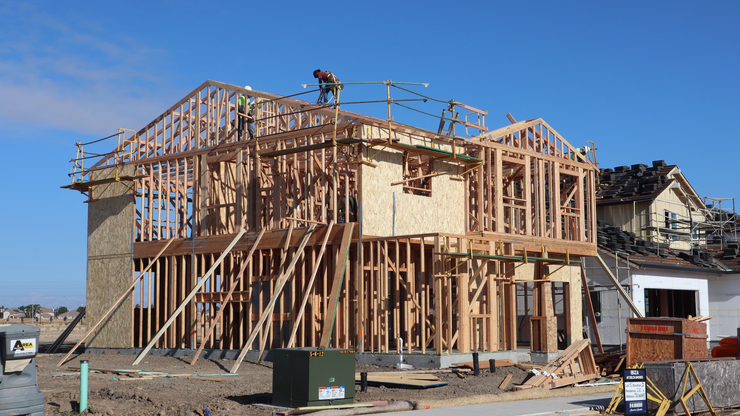 Construction crew working on a luxury home frame in South Florida