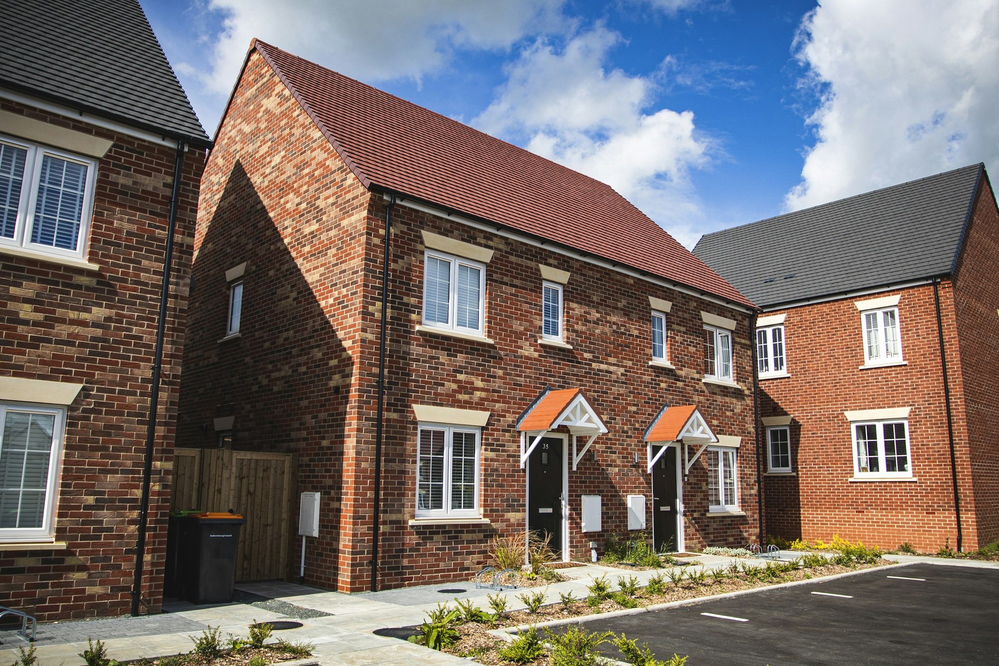 New-build red brick houses with new tiled roofs