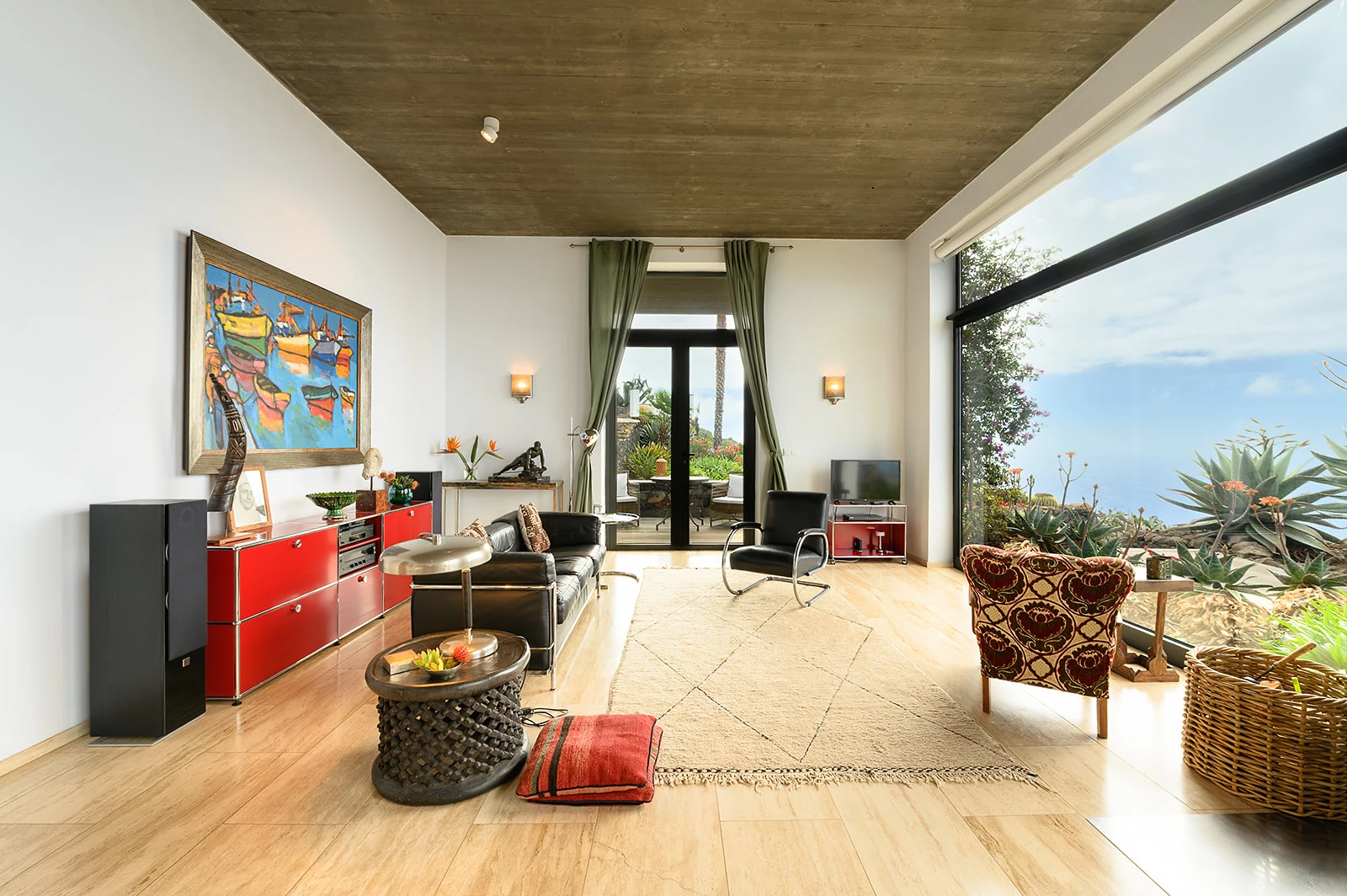 Open plan living room with artwork and ocean-view windows