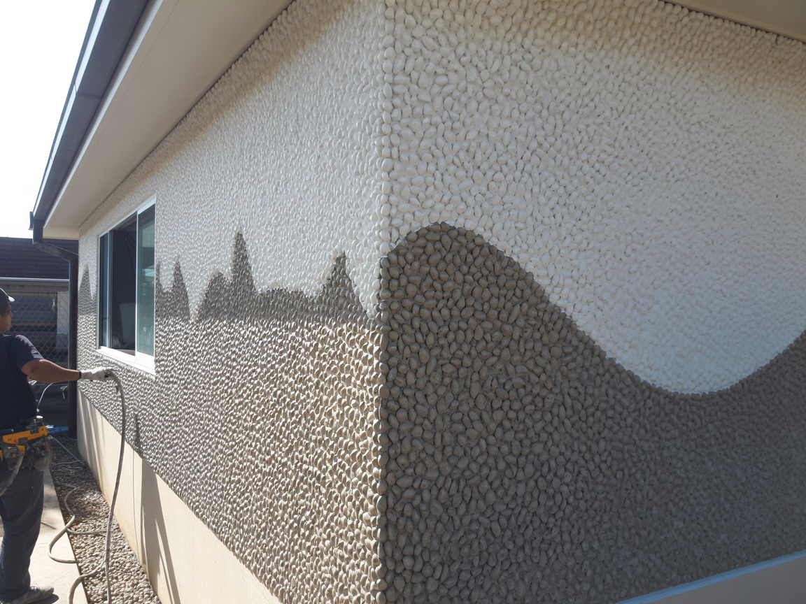 Pebble dash exterior wall being professionally cleaned and restored