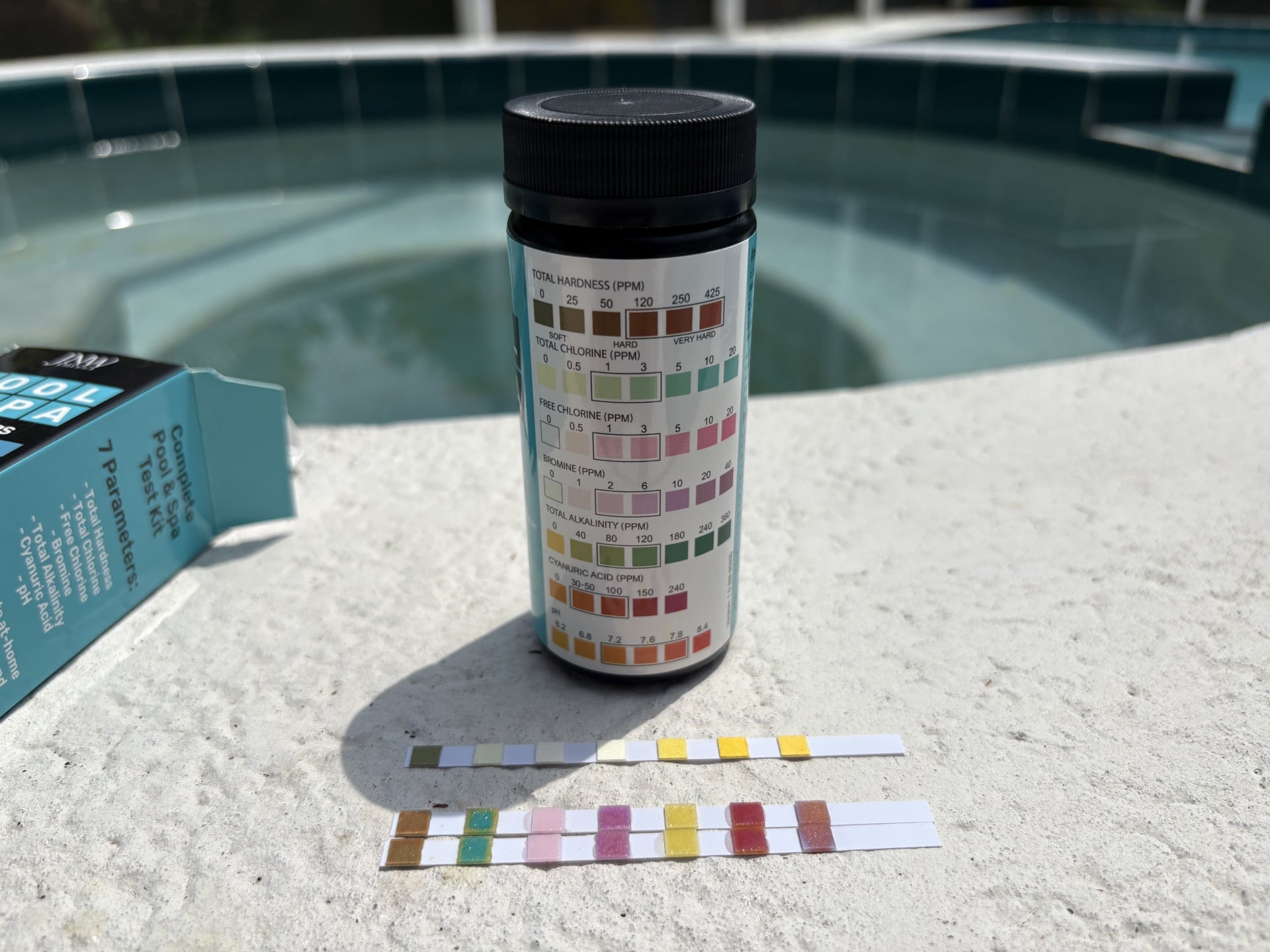 Pool chemical test kit with testing strips and vials for water balancing