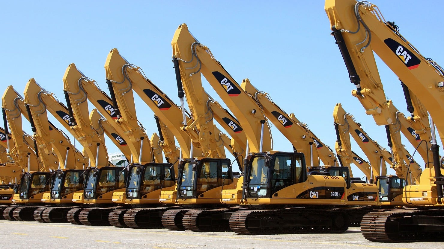 Fleet of heavy trucks and trailers at construction logistics yard