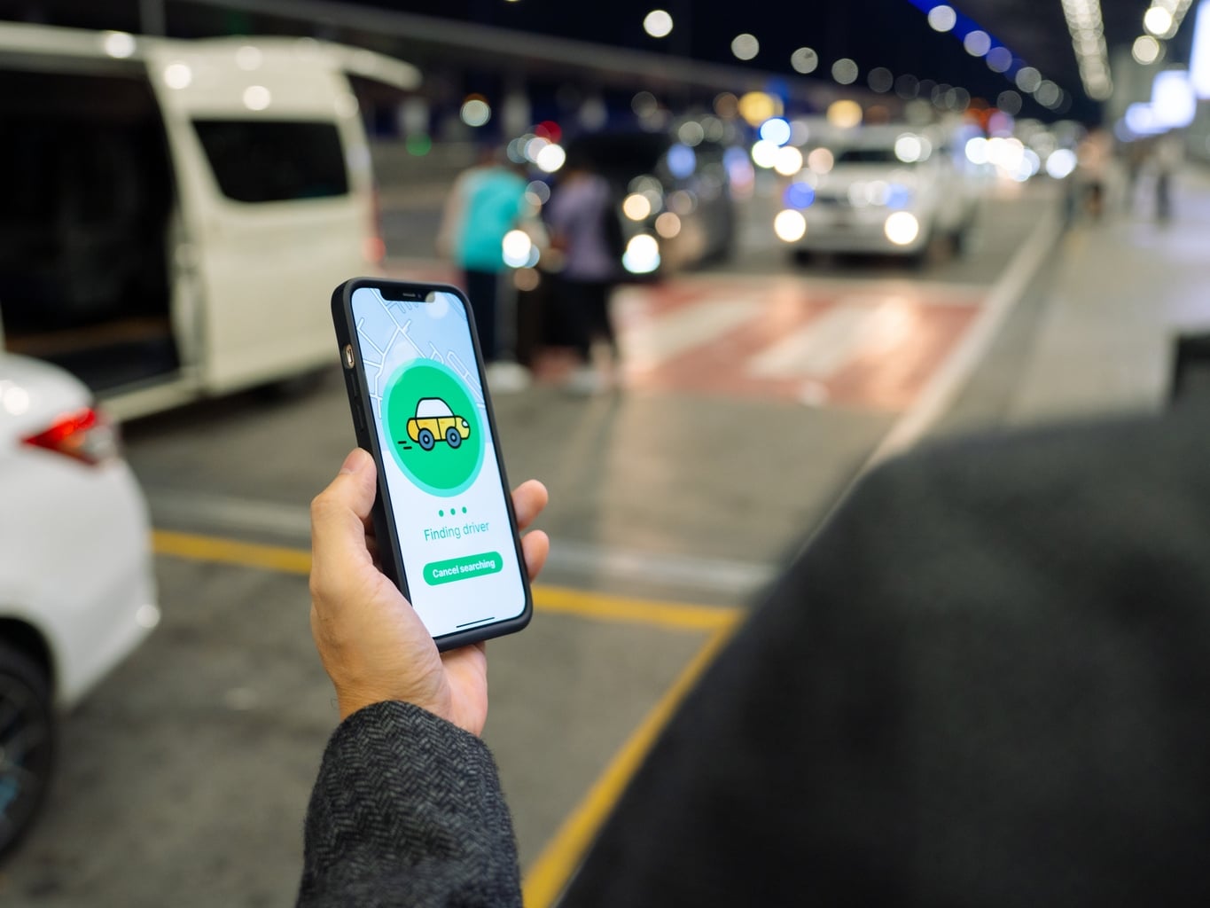 Person booking a ride on phone app