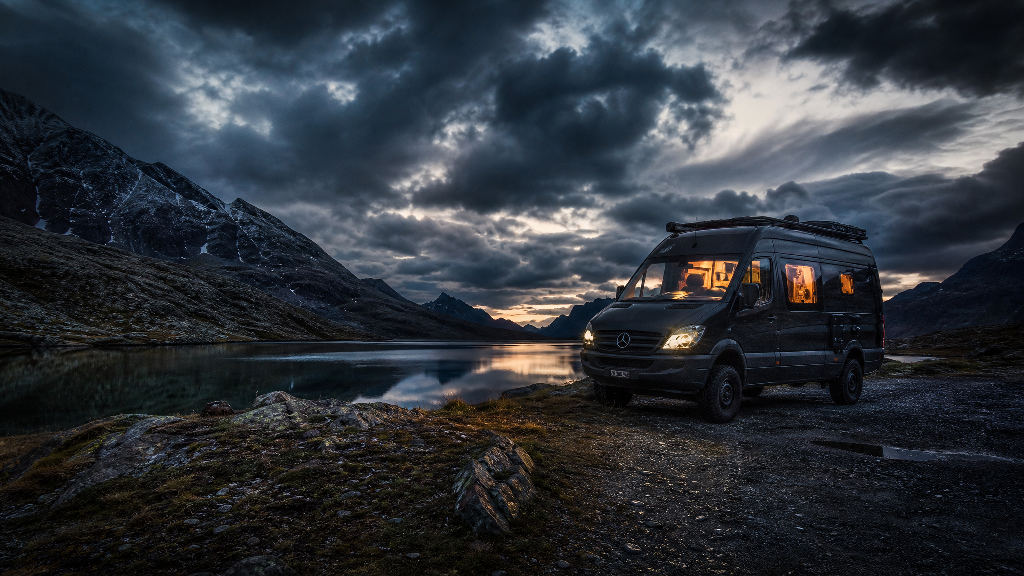 Dark campervan at mountain lake