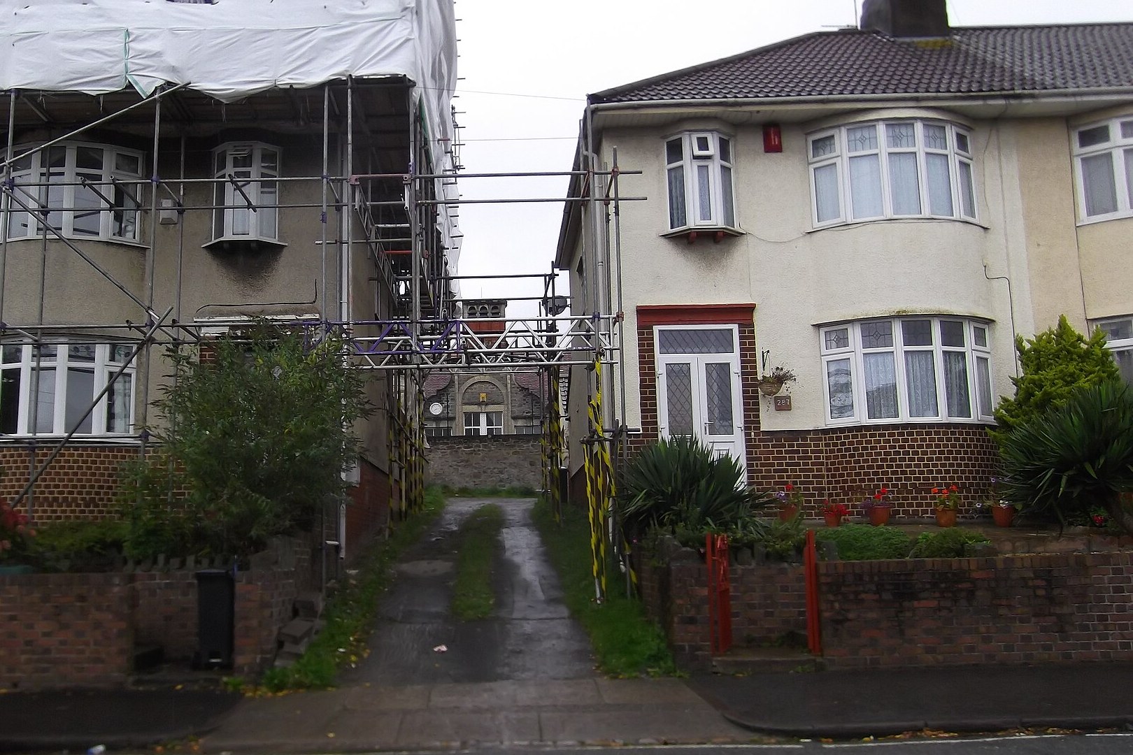 Scaffolding around semi-detached houses during re-roofing