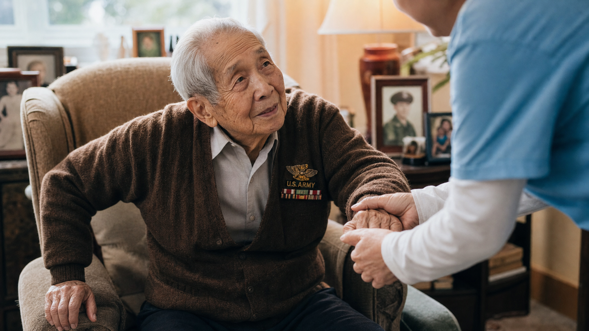 A frail senior Asian veteran being gently assisted at home by a caregiver