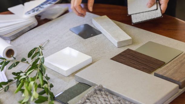 Interior designer reviewing material swatches alongside a photorealistic 3D room rendering — virtual staging and interior visualization services