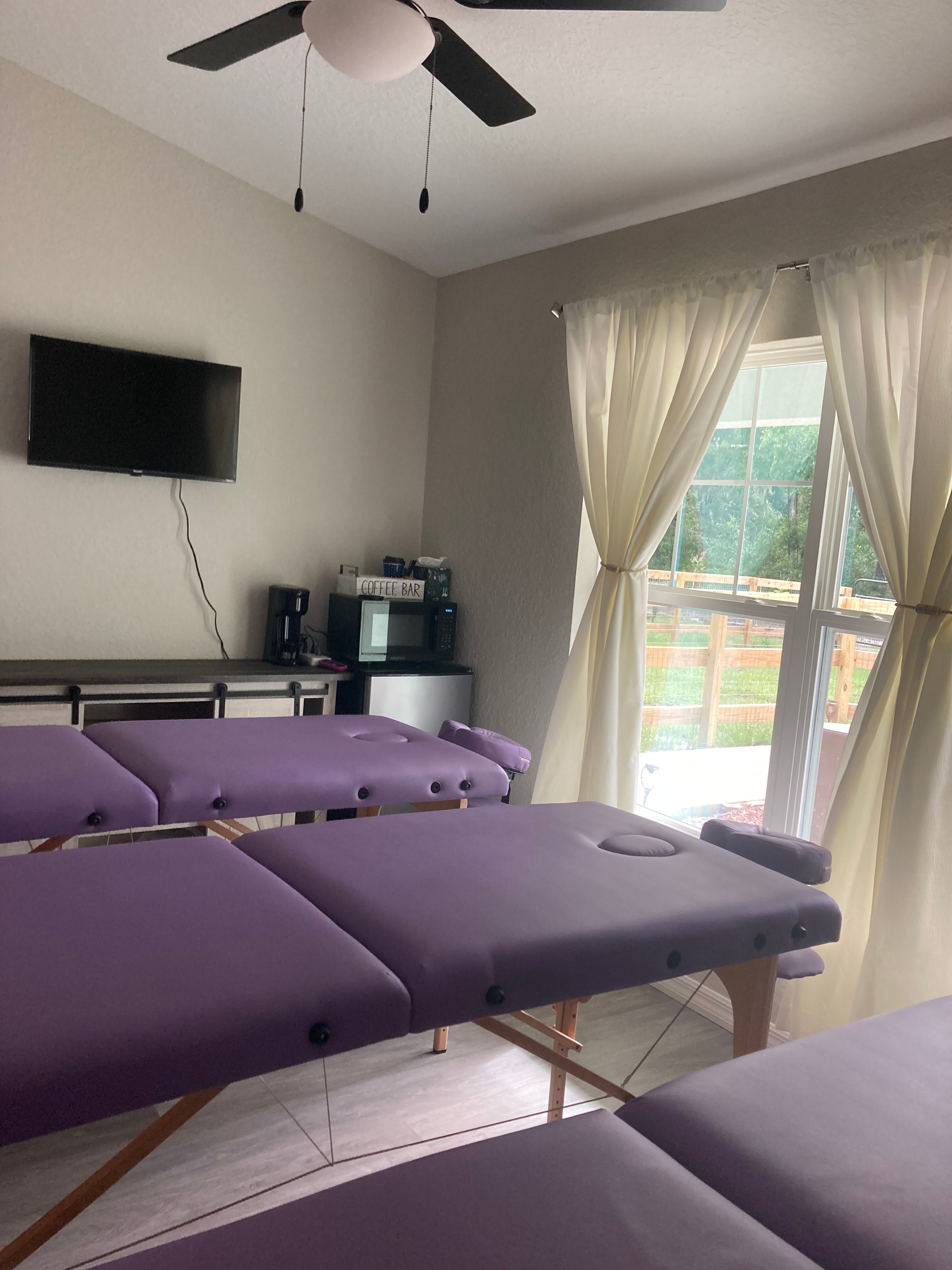 Studio room with lavender tables and elegant draping creating a calming atmosphere