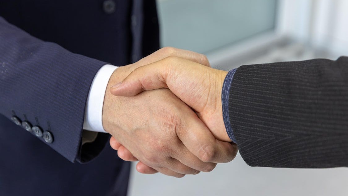 Professional business partnership handshake