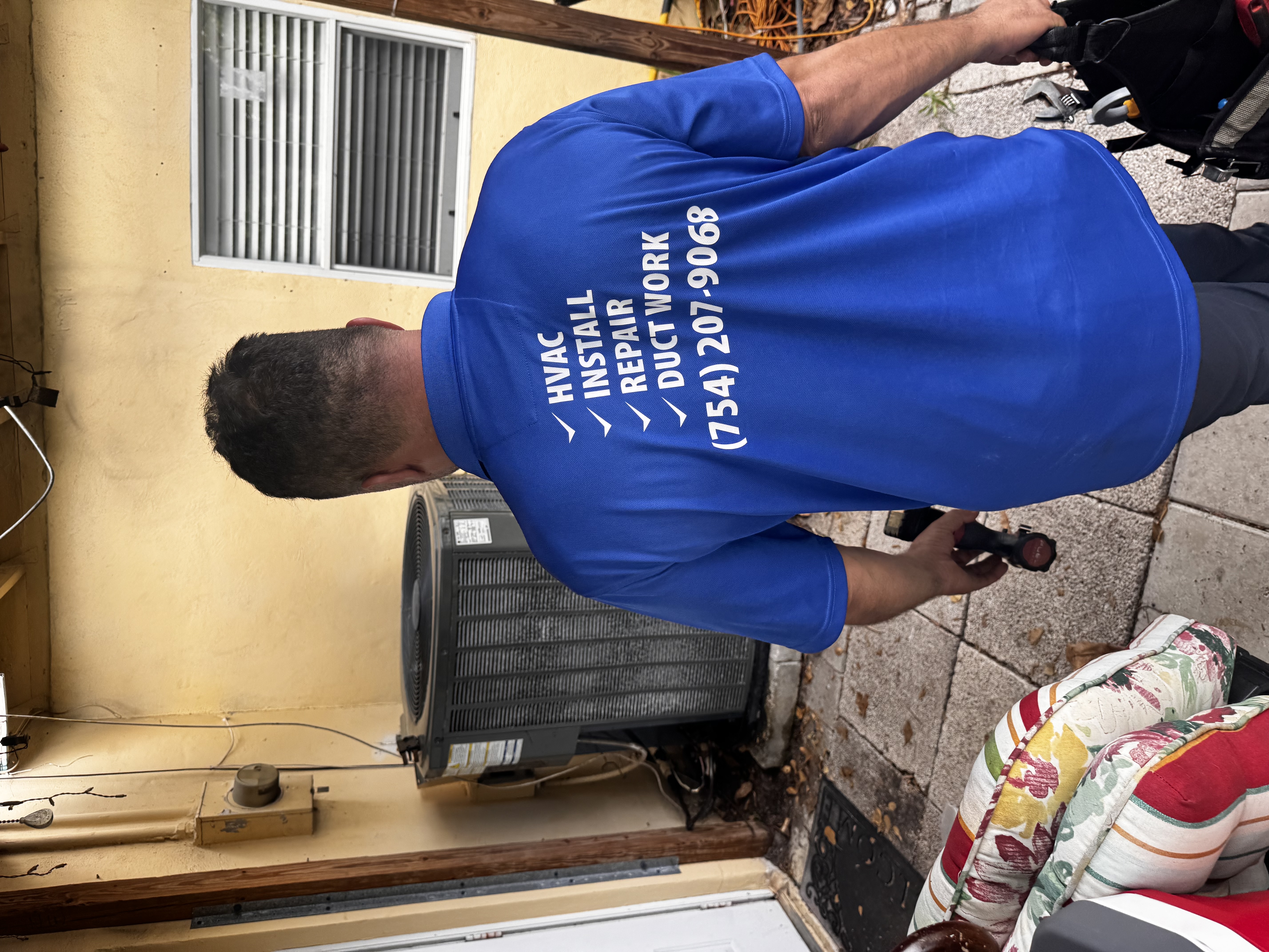 Weather Control HVAC technician working on AC unit