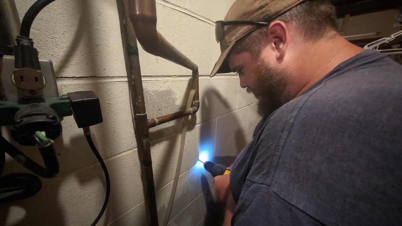 Professional technician installing water filtration system