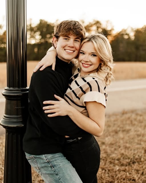 Landon and another adult posing together outdoors.