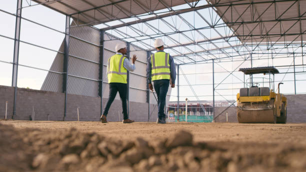 Workers inspecting warehouse under construction