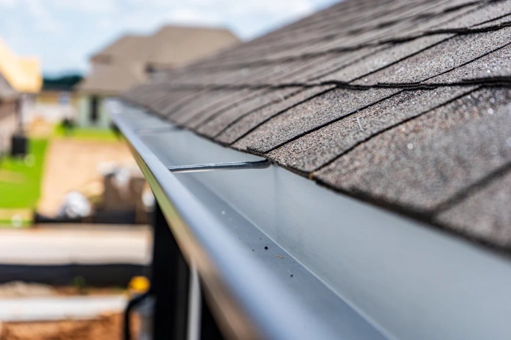 Clean roof gutters on house