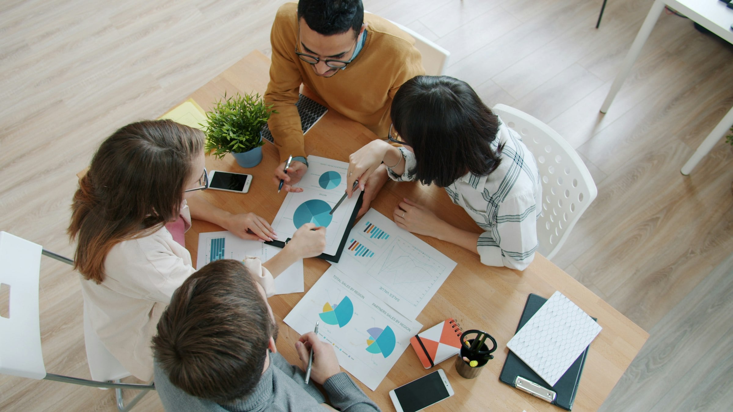 Practice owners reviewing financial reports and charts on a table