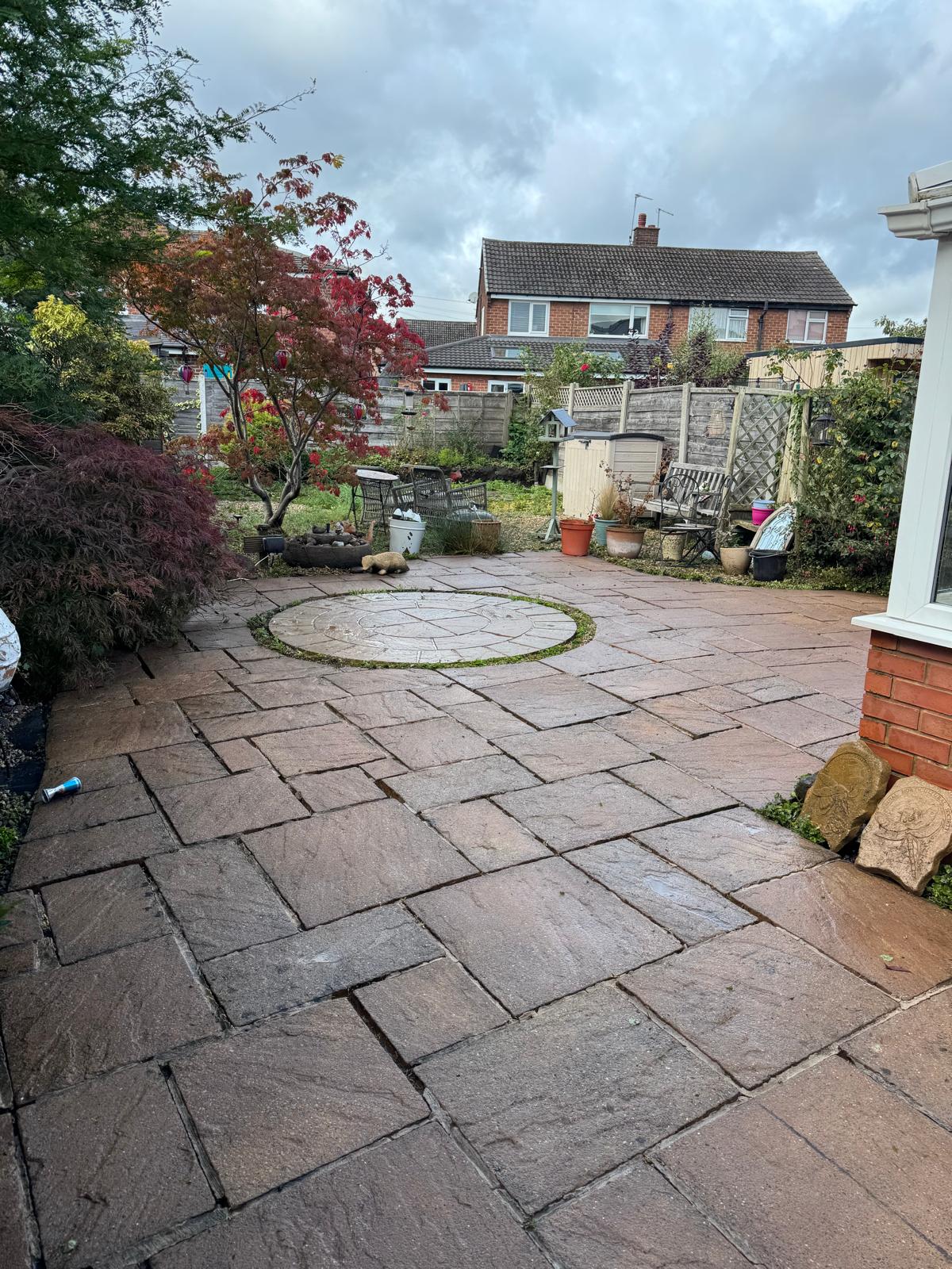 Back patio after cleaning - slabs restored, circular feature pristine