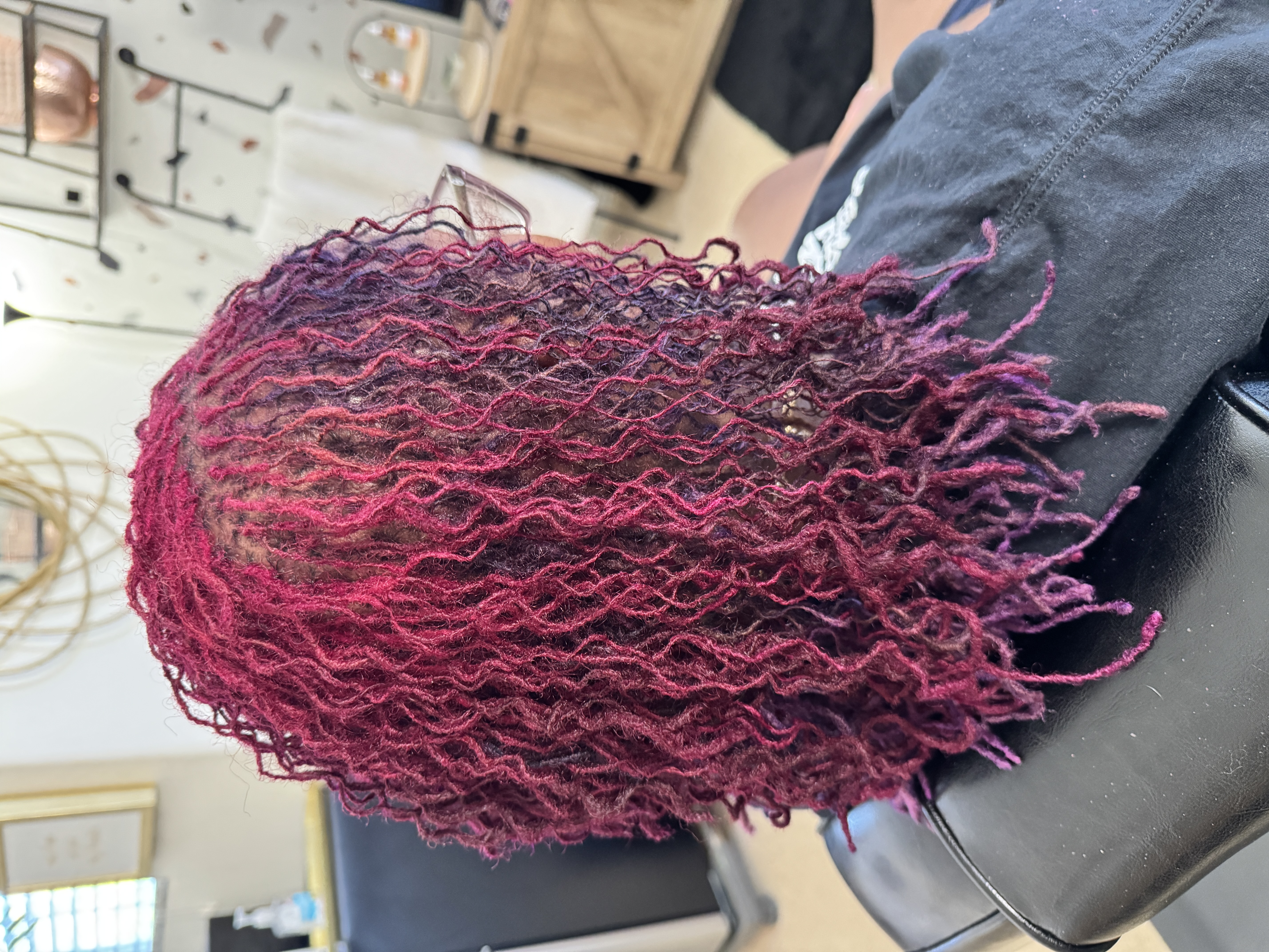 Stunning magenta-pink curled microlocks with vibrant color at CandieLocks salon Las Vegas