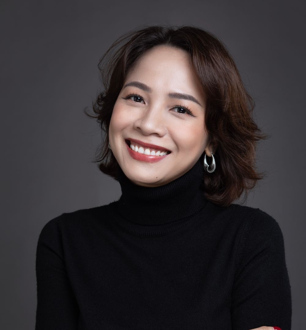 Professional portrait of an East Asian woman in dark attire serving as a veterans benefits advocate