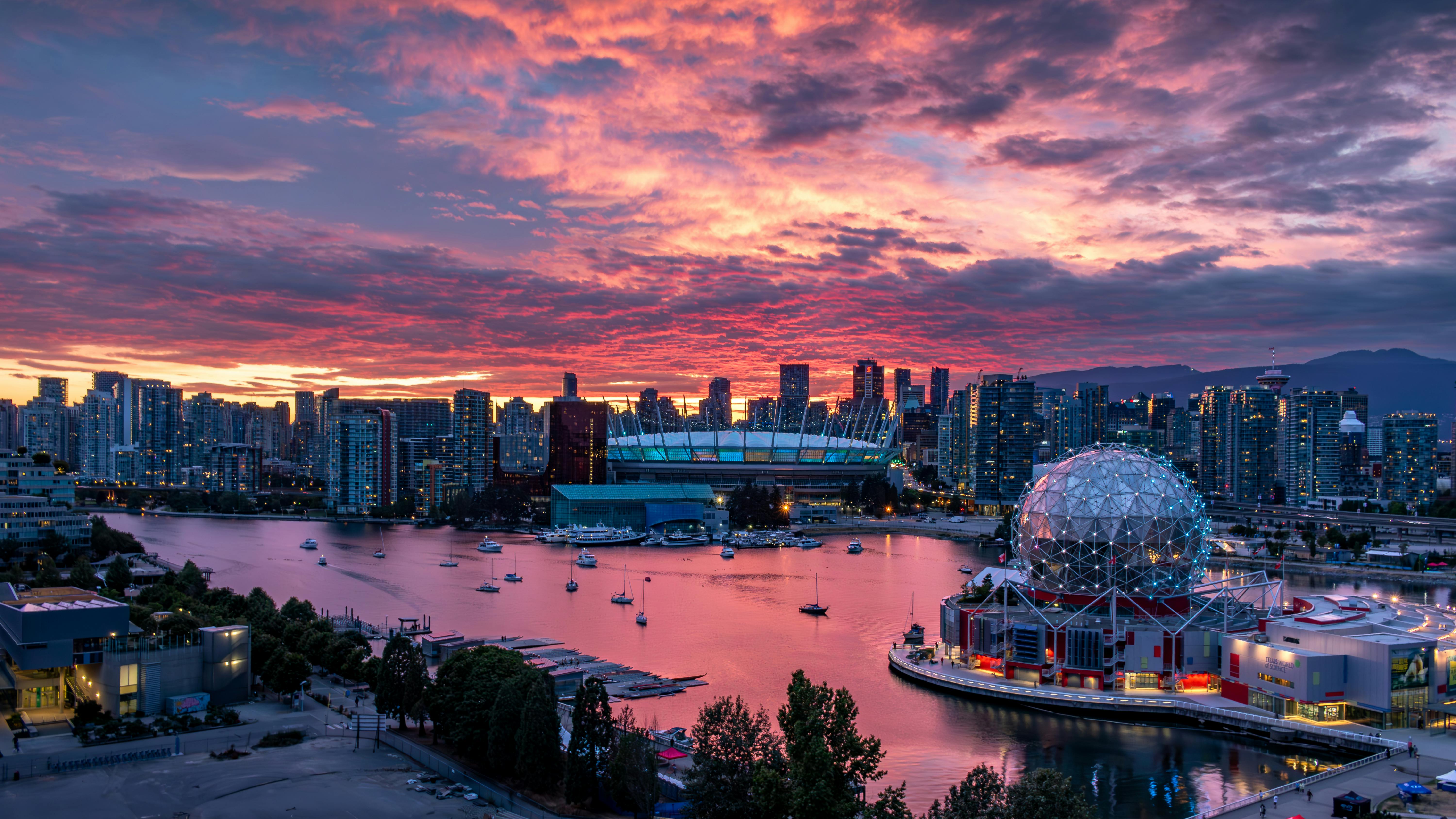 Vancouver downtown skyline with mountains and BC Place at golden hour