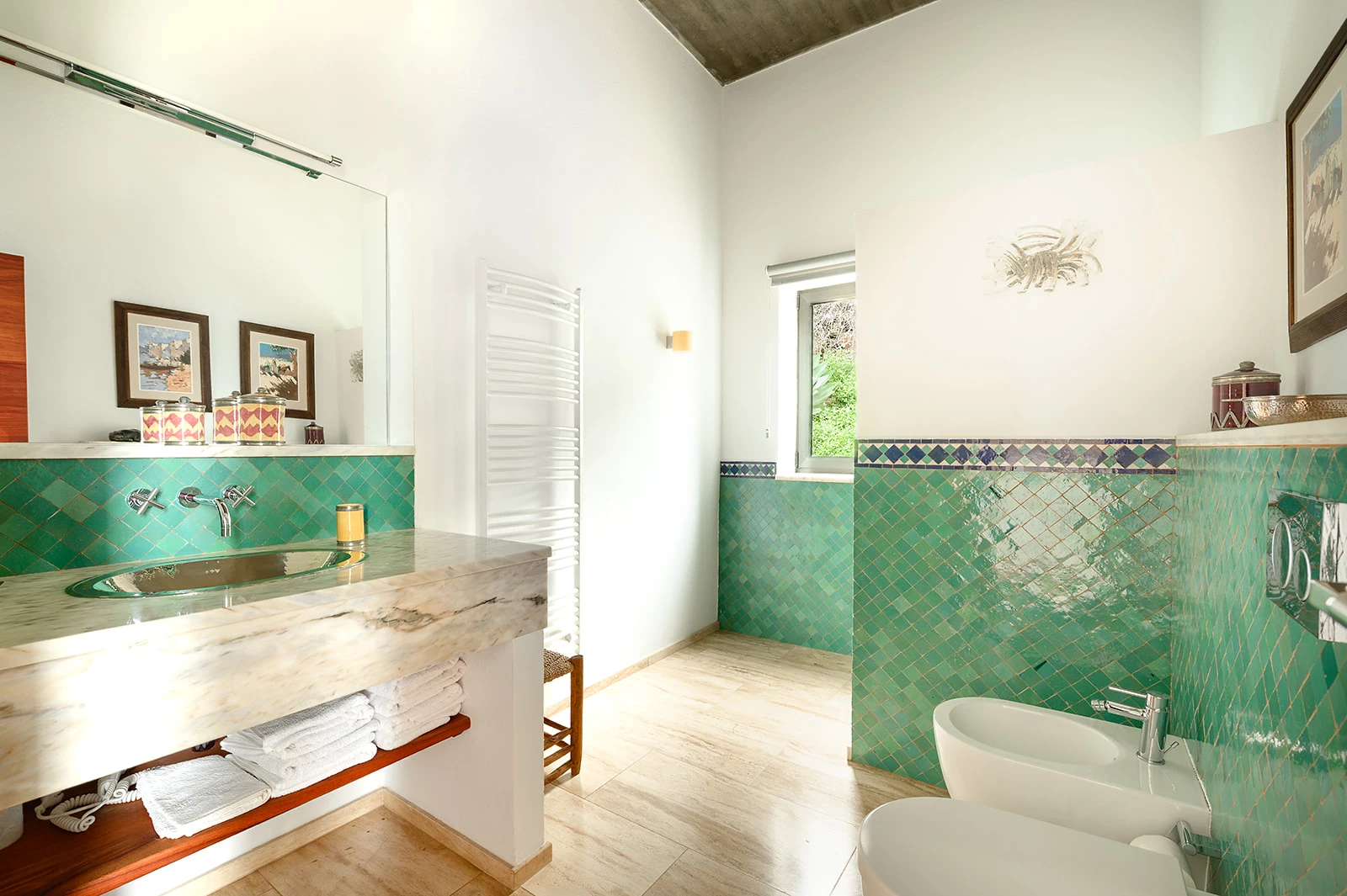 Bathroom with green marble tiles and tropical garden view