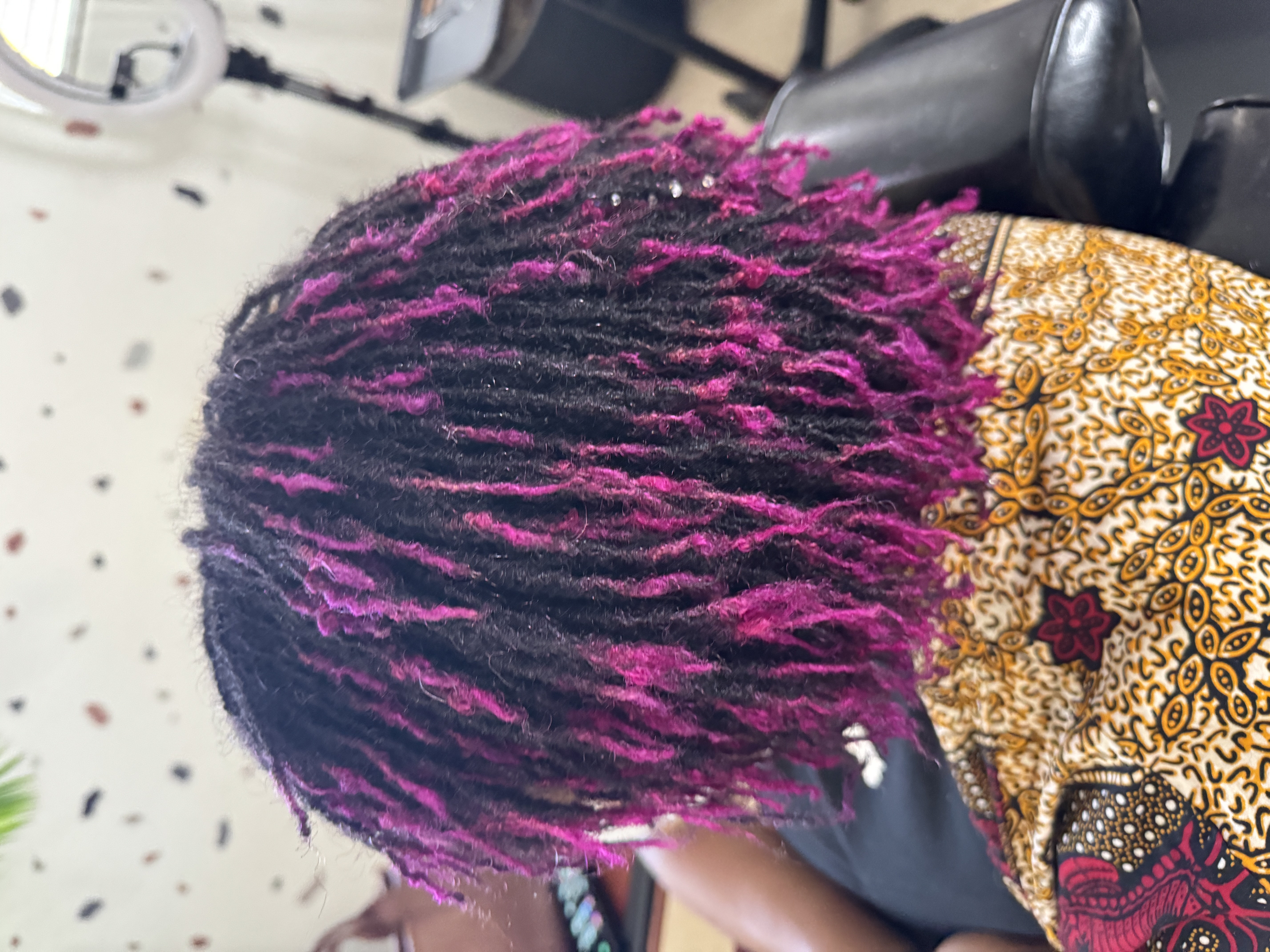 Bold magenta and black microlocks with striking color contrast styled by CandieLocks