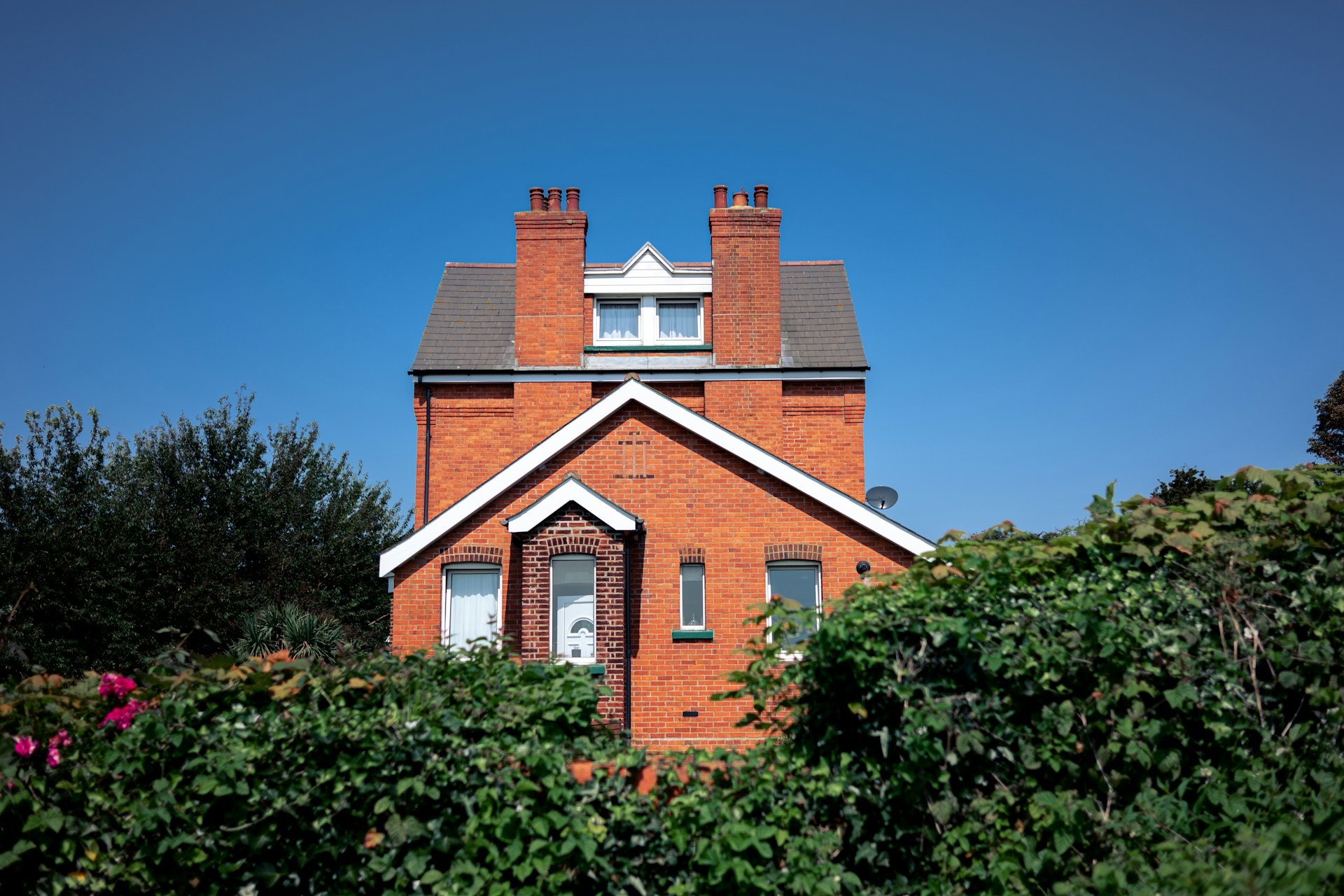 Red brick house with white roofline and bargeboards