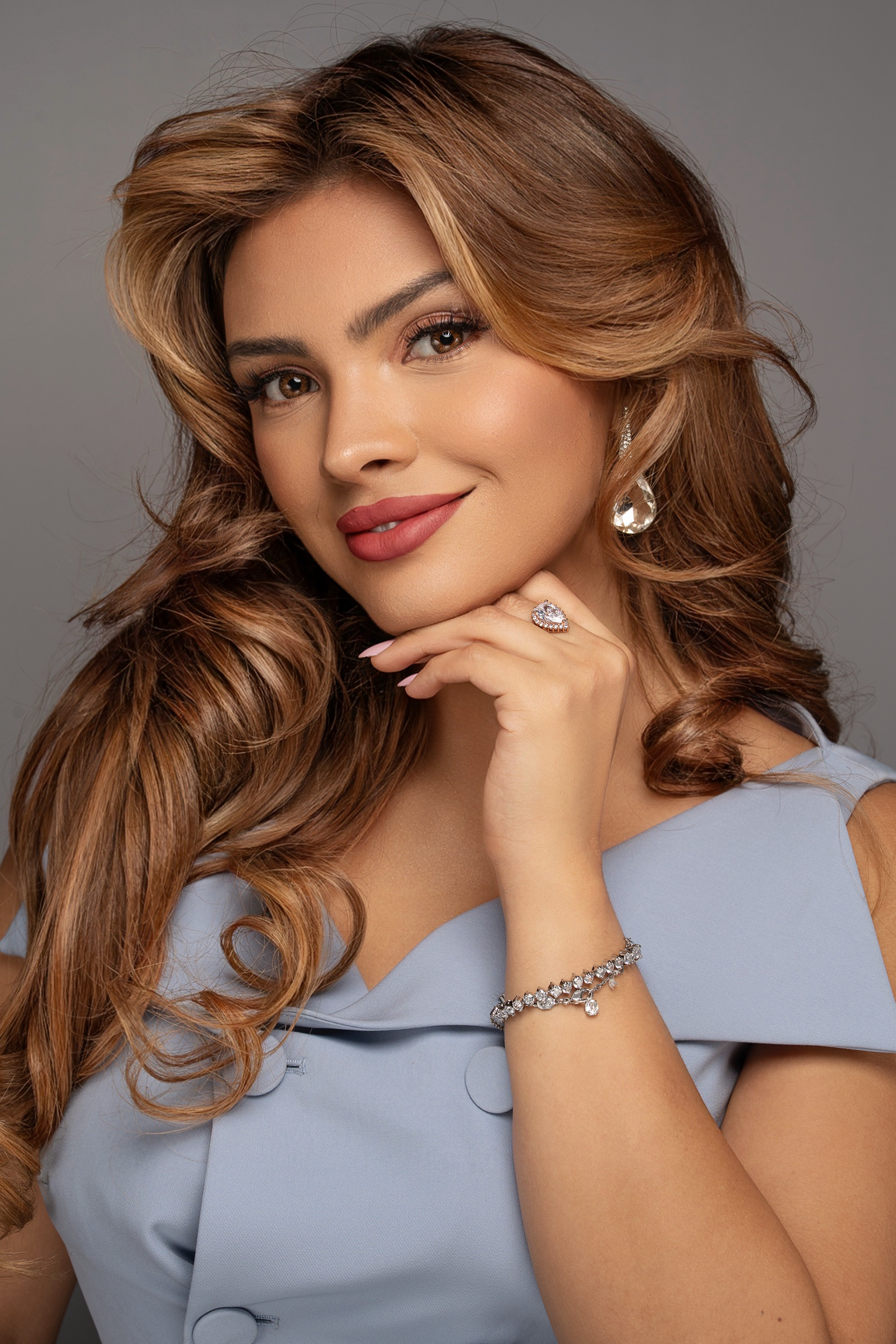Beautiful portrait in blue off-shoulder dress with crystal bracelet