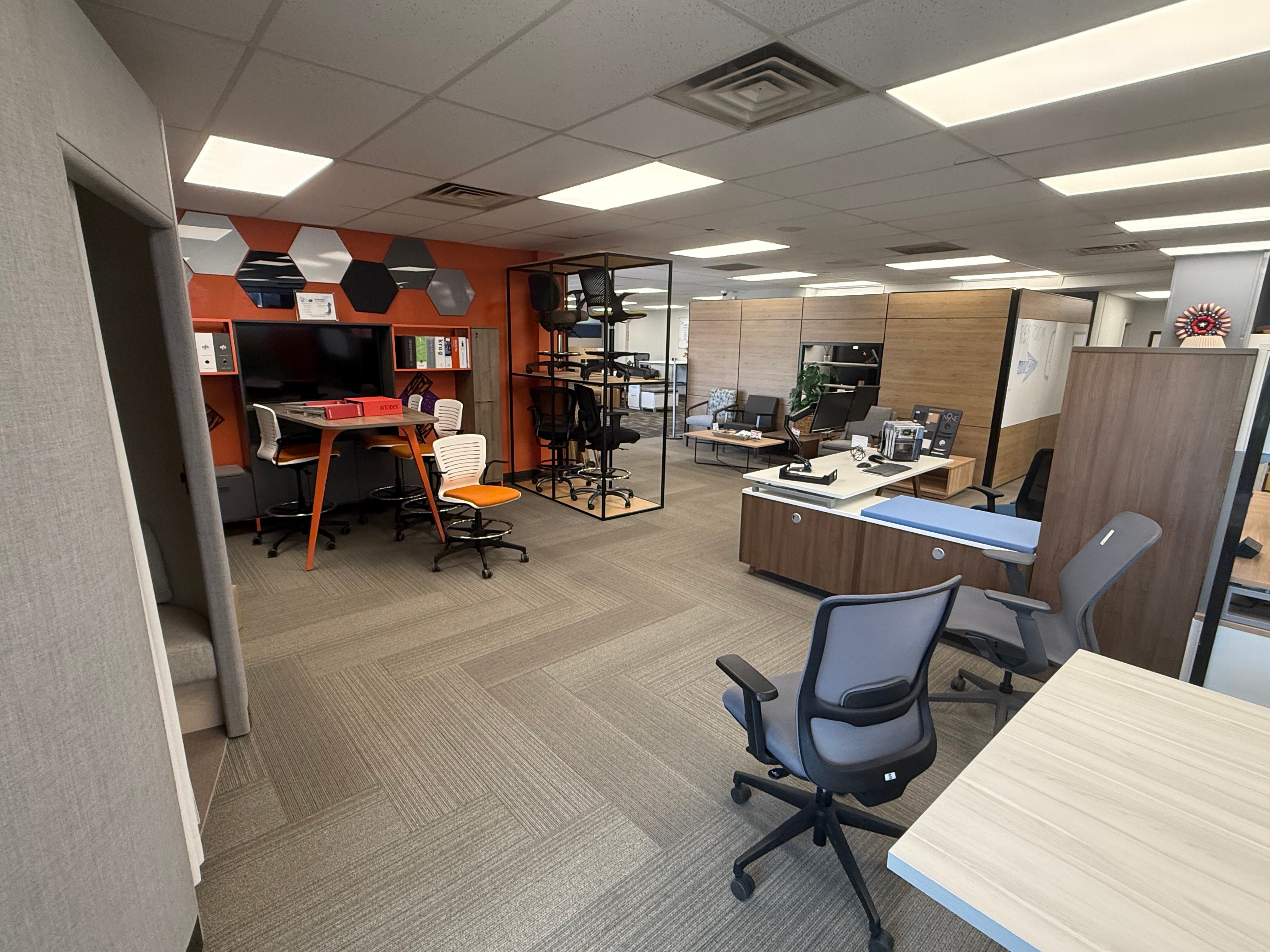 BFS showroom interior featuring desks, workstations, and the signature hexagon accent wall